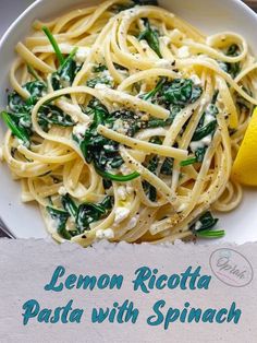 lemon ricotta pasta with spinach and fettuccine in a white bowl