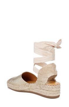 A graceful tie wrap completes this espadrille-inspired sandal balanced on a low wedge for walkable comfort. 1 3/4" heel; 3/4" platform Textile upper/synthetic lining and sole Imported Summer Espadrilles With Textured Sole And Ankle Strap, Chic Ankle Strap Espadrilles With Cushioned Footbed, Adjustable Flat Heel Platform Espadrilles, Adjustable Platform Espadrilles With Flat Heel, Beach Ankle Tie Lace-up Sandals With Heel Strap, Chic Gold Open Toe Espadrilles, Gold Espadrilles For Summer, Chic Wedge Heel Flats For Spring, Chic Spring Flats With Wedge Heel