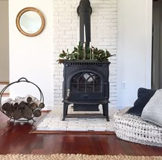 a living room filled with furniture and a wood burning stove in the middle of it