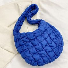 Nylon Puffer Solid Color Purse Tote Handbag Slouch Bag Blue Solid Color Puffer Nylon Slouch Bag. Fun Bright Colors! * 13" X 9.5" * Zipper Closure * 22" Long Strap * Water-Resistant Inner Lining * Zipper Interior Pockets Blue Packable Tote Shoulder Bag, Blue Quilted Nylon Bags, Trendy Packable Nylon Shoulder Bag, Packable Blue Nylon Bag, Blue Quilted Shoulder Bag For Everyday Use, Blue Nylon Shoulder Bag For Travel, Blue Quilted Travel Bags, Blue Nylon Shoulder Bag, Blue Quilted Tote Shoulder Bag