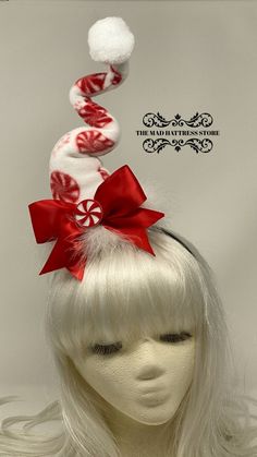 "You will be the life of the party with my new Peppermint Candy Swirly Hat! The hat is made of fun red and white Peppermint Candy fleece and is wired to adjust the \"squiggles\" as you choose. It is surrounded with white feathers, a Red bow accented with a felt \"peppermint\" and has a BIG white pom-pom on the top. The headband is removable allowing for personal preference in positioning on the head. Fascinators are typically worn off center on the right or left side of the head. Allows you to s Whimsical Adjustable Headband For Gifts, Whimsical Adjustable Headband For Gift, White Mini Hats For Winter Party, Whimsical Christmas Party Headband, Red Christmas Costume Hat And Headpiece, Red Christmas Costume Hat, Adjustable Christmas Costume Hats, Cute White Headpieces For Parties, Red Whimsical Mini Hats For Gifts