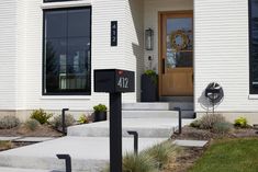 a white house with steps leading to the front door and number 511 on it