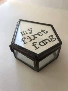 a small box that has some type of writing on it and is sitting on a table