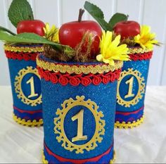 there are two blue pots with apples and flowers in them, one has the number one on it