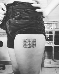 a woman with a tattoo on her thigh that says, be still justice before you dieing out