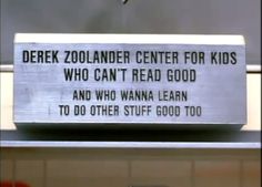 there is a sign on the side of a building that says, derek zoolander center for kids who can't read good and who wanna learn to do other stuff