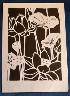 a black and white paper cut with flowers