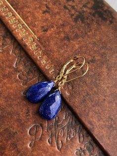 "Lapis Lazuli Earrings, Solid 14k Gold, Navy Blue Teardrop Earrings, Real 14k Gold, Simple Royal Blue Earrings, Yellow Gold Gift for Wife These earrings are made with authentic Solid 14k Gold, guarantied to never tarnish or give an allergic reaction. Ideal for an anniversary gift, or that \"something blue\" for a bride, these lapis earrings are a forever piece of jewelry that can remain in your family for generations to come. - Stone: Lapis Lazuli - Birthstone Month: September - Stone Size: 14 m Blue Pear-shaped Earrings For Gift, Elegant Sapphire Jewelry With Ear Wire, Classic Blue Teardrop Jewelry, Blue Briolette Teardrop Earrings For Gift, Nickel-free Yellow Gold Briolette Earrings, Nickel-free Briolette Yellow Gold Earrings, Blue 14k Gold Drop Earrings, Nickel-free Pear-shaped Earrings For Gifts, Elegant Sapphire Earrings With Ear Wire