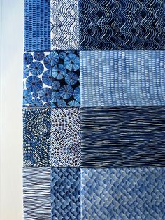 blue and white quilts are arranged together