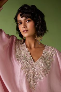 Baby pink kaftan with ivory resham, pearl, zardozi embroidery on neckline and cuff hem. Paired with straight pant.
Components: 2
Pattern: Embroidery
Type Of Work: Zardozi, resham, pearl
Neckline: V neck
Sleeve Type: Batwing sleeves
Fabric: Pure Silk
Color: Pink
Other Details: 
Note: Only the product mentioned in the description is being sold
Occasion: Destination Wedding - Aza Fashions V Neck Embroidery Design, Zardozi Embroidery Designs, Mrunalini Rao, Pink Kaftan, Embroidery Borders, Egypt Jewelry, Desi Dress, Embroidered Kaftan, New Embroidery Designs