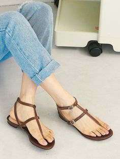 Editor's NotePretty yet comfy sandals will complete your summer look- Gladiator-like strappy sandals- Adjustable fit with the buckles on the straps- The ankle strap secures the feet- Flat design that goes with everything in the summerMeasurement (inch)- KR230(US 6)-KR255(US 8.5)- Height 0.4in.* Fits true to the size* Please refer to the size chartComposition & Care- Goat skin* Deformation or discoloring might happen if in contact with humid air or high temperature* Avoid rain and snow* Toe Post Strap Sandals For Summer, Summer Toe Post Sandals With Strap, Brown T-strap Footbed Sandals For Summer, Toe Post Strap Sandals For Spring, Spring Toe Post Sandals With Strap, Strappy Toe Ring Sandals With Removable Insole For Summer, Summer T-strap Sandals With Adjustable Straps, Spring T-strap Sandals With Buckle Closure, Summer Toe Ring Sandals With Adjustable Ankle Strap