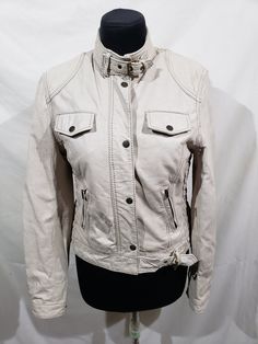 Delightful women's leather jacket. Beige women's jacket with metal zippers and buttons. Jacket by Flash. The jacket is made of durable soft beige genuine leather. The jacket fastens with a metal zipper and a leather strap with metal buttons. There is a belt with a metal buckle at the bottom of the jacket. At the bottom of the jacket there are two pockets with metal zippers. On top of the jacket there are two secure pockets with flaps on the snap. Jacket cuffs are fastened with metal buttons. On the sides of the jacket there is a decorative elastic band, which has a sewn-in metal zipper, with which you can increase the volume of the bottom of the jacket. The jacket has a stand-up collar with a belt and a metal buckle. The jacket has a nice cotton lining. The durable leather of the jacket pr Cream Leather Long Sleeve Jacket, Beige Leather Jacket With Zipper Closure, Cream Leather Jacket With Long Sleeves, Cream Long Sleeve Leather Jacket, Beige Leather Outerwear With Zipper Closure, Cream Leather Jacket With Zipper For Spring, Beige Leather Jacket With Button Closure For Spring, Spring Beige Leather Jacket With Button Closure, Long Sleeve Cream Leather Jacket