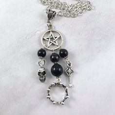 This beautiful chain necklace is the perfect way to express your affinity for the Greek god Hades. Charms: Skull Crown Key 3 genuine golden obsidian beads and one garnet bead also make up the pendant. Your choice of top charm: Pentacle or Chandelier Secures with a lobster clasp. Chain is stainless steel and is available in a variety of lengths. (A two inch extender can be added to the end upon request.) Charms are zinc alloy. All materials are lead and nickel free. Comes in a jewelry box so it's The Underworld Greek Mythology, Underworld Greek Mythology, God Of The Underworld, Greek Mythology Jewelry, Skull Crown, Mythology Jewelry, Golden Obsidian, Goddess Jewelry, Chain Making