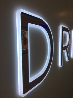 a sign that is lit up in the shape of a letter and it says direct