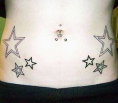 a woman's stomach with stars on it and a piercing in the middle of her belly