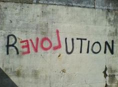 graffiti on the side of a building that says revolution written in red and black ink