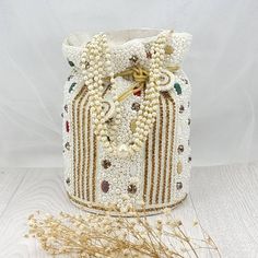 Jasmin Handcrafted Intricate Bridal White Gold Pearl Potli bag with draw string and Pearl hanging for closure Perfect for evening parties and a special ocassion.  This item made of is 80 cotton & 20% handwork We try to take pictures as normal as we can but colors may slightly vary due to different lighting setups. Please note: No Returns No Exchange. But If you have any issue with your order, Kindly contact us before leaving a review Potli Bag, Pearl Stone, Potli Bags, Lighting Setups, Pakistani Jewelry, Nose Jewelry, Evening Purse, Gold Pearl, Stone Beads