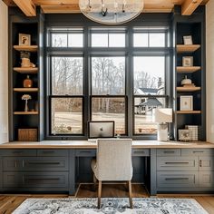 a home office with built - in desk and shelves