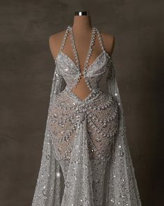 the back of a dress with sequins on it and an open neckline