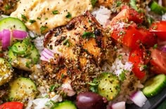 a close up of a plate of food with meat and vegetables on top of rice