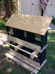 three crates stacked on top of each other in the grass