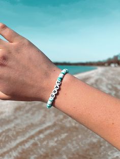 Sunkissed Sandbanks  ✨ This Beach Surfer Style bracelet is perfect for all your summer endeavours. It is handmade of polymer clays beads which are known to be quite durable. ✨ SIZING: Each bracelet measures around 6.5 inches which fits great for most teens and adults. However please contact me if you would like a custom length!  💌 FREE SHIPPING! - Through Canada Post Oversized Lettermail Feel free to message me with any questions, I will typically respond within 24 hours. I'm a teen who makes a Casual Friendship Bracelets With 8mm Beads For Beach, White Adjustable Name Bracelet For Beach, Adjustable White Name Bracelet For Beach, Personalized White Name Bracelet For Beach, Casual Turquoise Beaded Bracelets With Letter Beads, White Strand Bracelet With Letter Beads, Casual Turquoise Beaded Bracelet With Letter Beads, Personalized White Beaded Bracelets For Summer, Green Beaded Bracelets With Letter Beads For Vacation