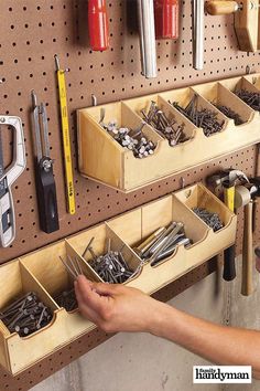 a man is working in his garage with tools on the pegboard and hanging from the wall