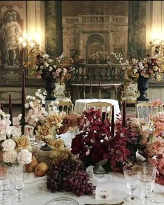 a table is set with flowers, candles and fruit for an elegant wedding reception in the state dining room