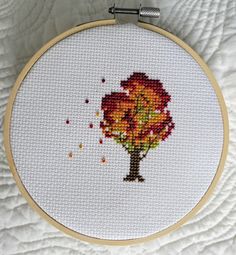 a cross stitch tree with leaves on it