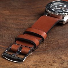 After years of creating leather watch straps for ourselves for use on a variety of watches, we are excited to release our version of the simple NATO leather strap. The NATO strap has an iconic history for a range of vintage military issued watches. We've tested this strap on a variety of watches, from Tudor and Timex to Luminox. It's a beautiful addition to new and vintage watches. Three widths available: 18mm, 20mm, and 22mm, sewn with durable dark brown poly cording. All straps are precisely c Watch Photography, Nato Strap Watches, Nato Strap, Vintage Classics, Military Watches, Watch Straps, Leather Watch Strap, Vintage Military, Leather Projects