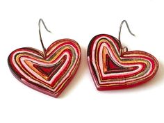 two heart shaped wooden earrings on a white background