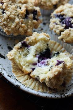 some blueberry muffins are sitting on a plate