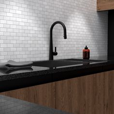 a kitchen sink with a faucet and soap dispenser on the counter