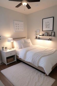 a bedroom with white bedding and pillows