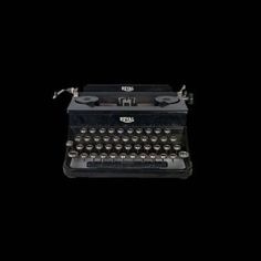 an old fashioned typewriter on a black background