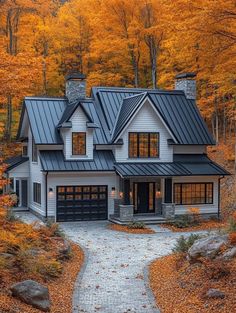 a house in the woods surrounded by fall foliage and trees with orange leaves on it