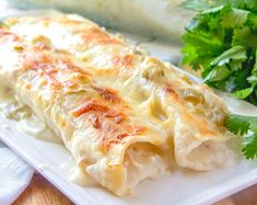 white chicken enchiladas on a plate with parsley