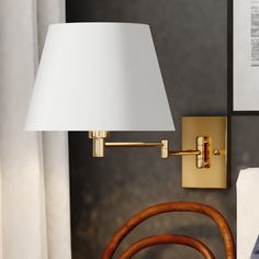 a lamp that is on the wall next to a chair