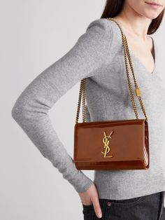 SAINT LAURENT's 'Kate' bag has been made in Italy from glossy patent-leather that's punctuated with the label's iconic 'YSL' logo plaque. This compact style is sized to fit all the essentials and has a sliding chain strap that can either be worn on your shoulder or cross-body - tuck it away to carry yours as a clutch.<br><br>Lower-Impact Materials. This product is made using at least 50% lower-impact materials or ingredients. Find out more about our NET SUSTAIN criteria <a href="https://www.net-a-porter.com/en-gb/campaigns/net-sustain">here.</a> Luxury Leather Shoulder Bag With Glossy Finish, Designer Patent Leather Bag With Glossy Finish, Luxury Patent Leather Bags For Formal Occasions, Luxury Bags With Glossy Finish For Formal Occasions, Luxury Glossy Formal Bags, Luxury Glossy Finish Formal Bags, Luxury Glossy Finish Shoulder Bag, Elegant Patent Leather Bag With Glossy Finish, Classic Leather Shoulder Bag With Glossy Finish