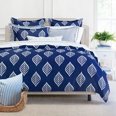 a bed with blue and white comforters in a bedroom