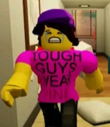 a lego character is walking down the hallway with a sign that says tough guys yeah