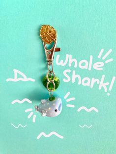 a keychain with an animal charm attached to it that says whale shark on the front