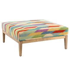 a multicolored footstool with wooden legs