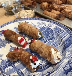 some food is laying out on a blue and white plate with other foods in the background