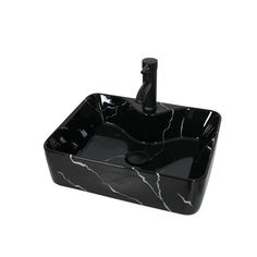 a black marble sink with a faucet in the middle and a toothbrush holder at the bottom