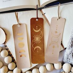 three bookmarks hanging from strings next to eggs