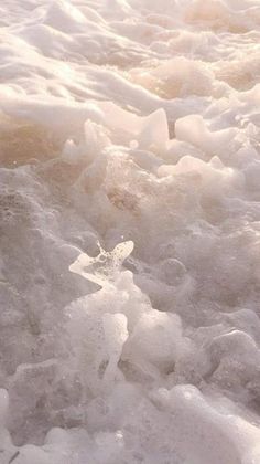 an orange fire hydrant sitting in the middle of some ice