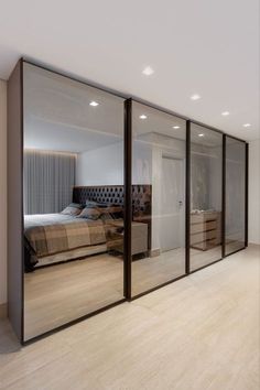 a bedroom with mirrored walls and wooden floors