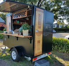 an outdoor coffee cart parked in the grass