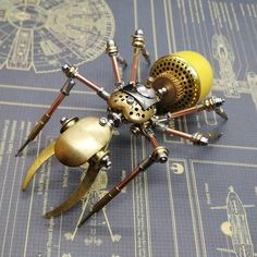 a spider made out of metal parts on top of a table